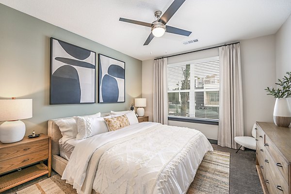 Bedroom with contemporary decor and ample natural light at Presidium Park Apartments