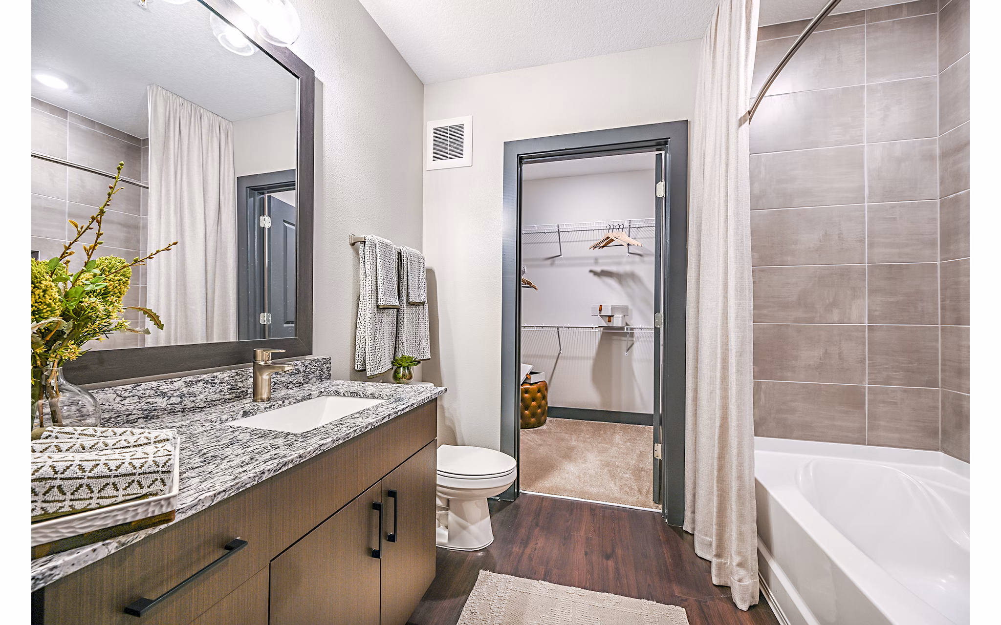 Bathroom featuring modern fixtures and tiles in Presidium Park Apartments