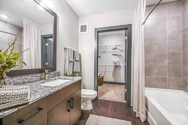 Bathroom featuring modern fixtures and tiles in Presidium Park Apartments