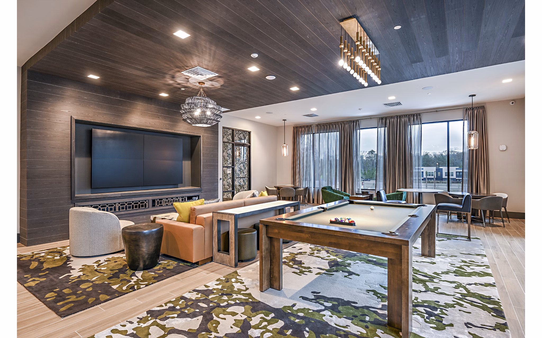 Clubhouse game room with pool table and modern seating at Presidium Park Apartments, offering a luxury social space for residents