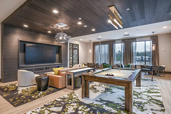 Clubhouse game room with pool table and modern seating at Presidium Park Apartments, offering a luxury social space for residents