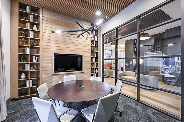 Spacious clubhouse meeting facility at Presidium Park Apartments featuring modern design and ample seating options