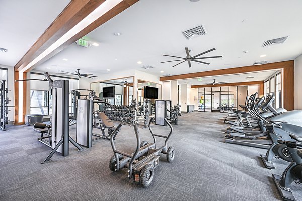 Fitness center at Presidium Park Apartments with modern gym equipment and spacious workout area