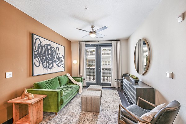 Spacious living room with modern decor and natural light in Presidium Park Apartments
