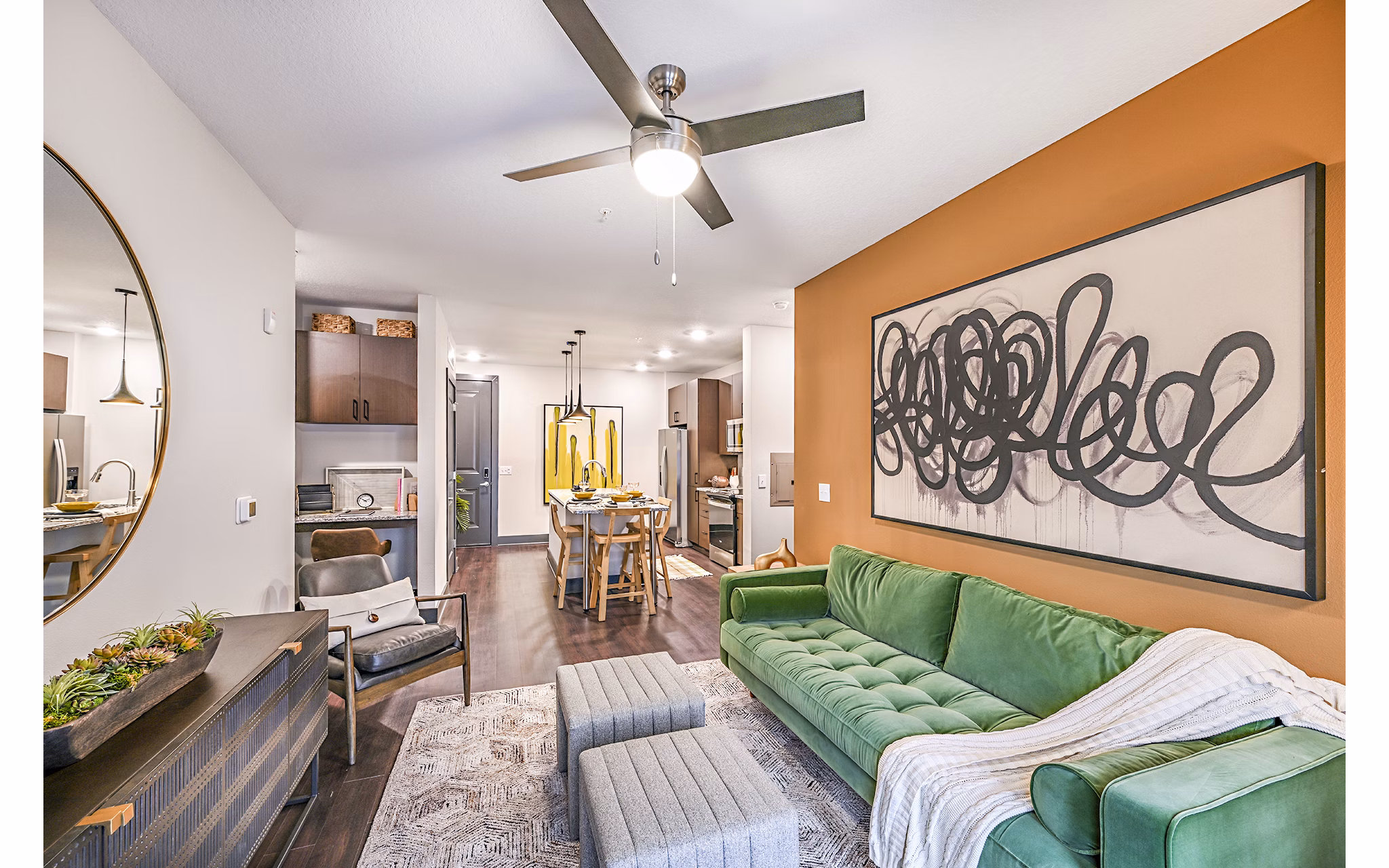 Spacious living room with modern decor at Presidium Park Apartments featuring comfortable seating and ambient lighting