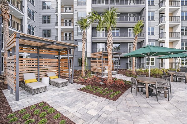 Poolside cabana at Presidium Park Apartments offering shaded seating and relaxation area