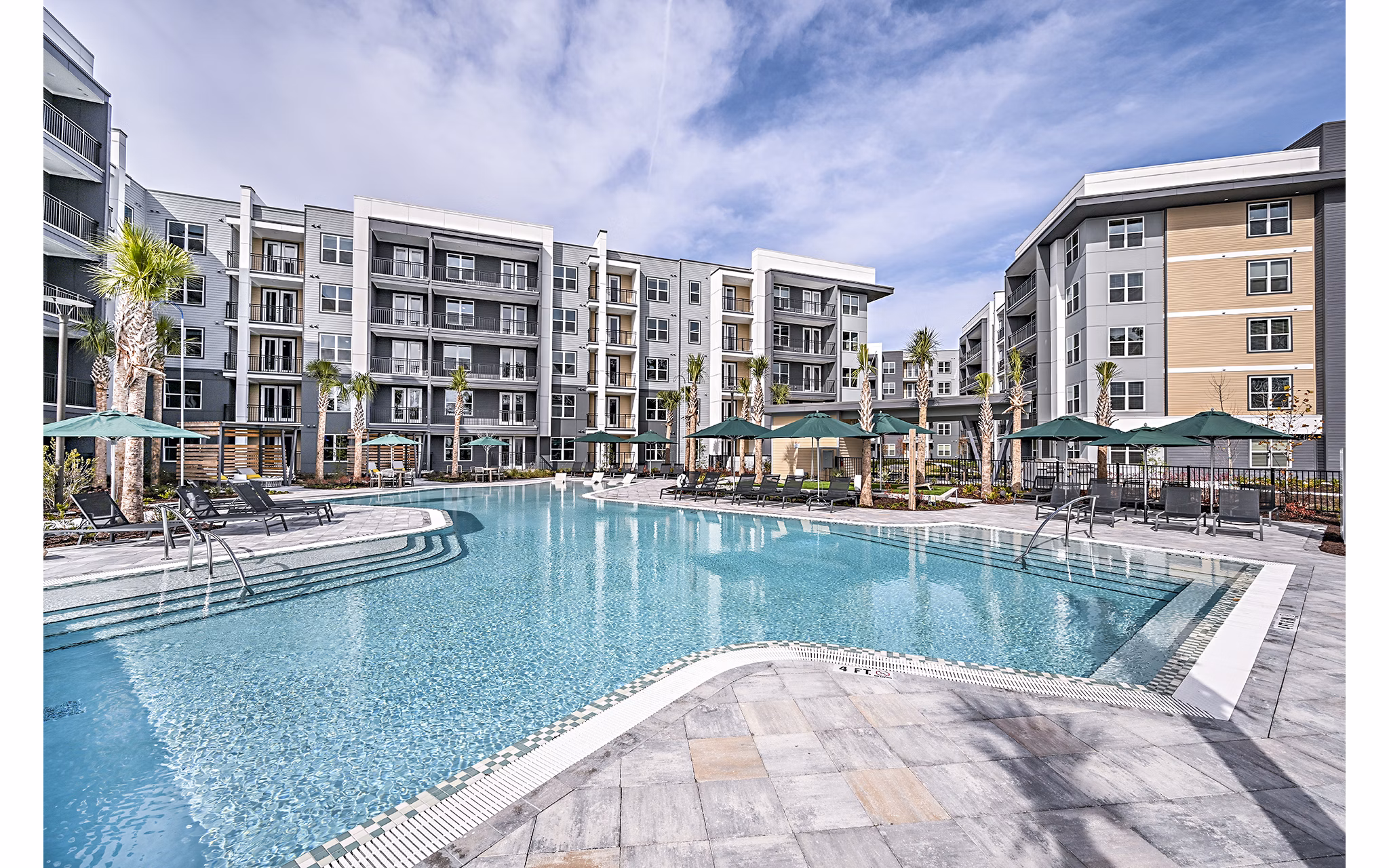 Resort-style pool with sundeck at Presidium Park Apartments offering luxury living amenities