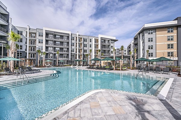 Resort-style pool with sundeck at Presidium Park Apartments offering luxury living amenities
