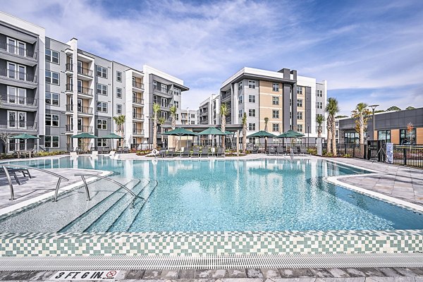 Resort-style pool surrounded by lush landscaping at Presidium Park Apartments