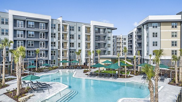 Resort-style pool with lounge chairs at Presidium Park Apartments, offering a luxurious outdoor experience