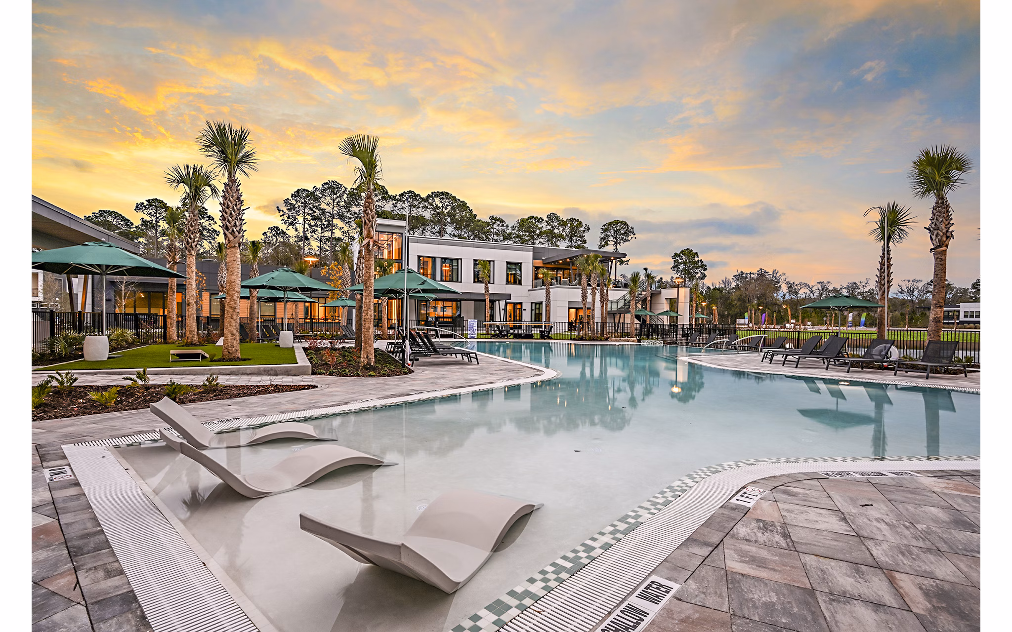 Luxurious poolside retreat at Presidium Park Apartments with lush landscaping and comfortable lounge chairs, perfect for relaxation and leisure activities