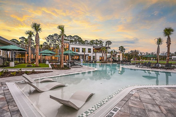 Luxurious poolside retreat at Presidium Park Apartments with lush landscaping and comfortable lounge chairs, perfect for relaxation and leisure activities