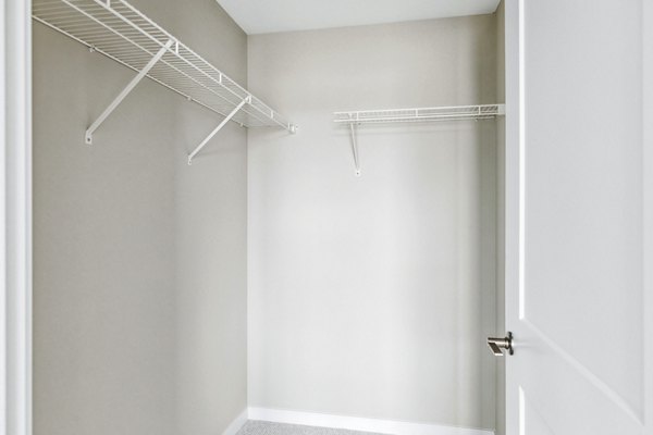 Spacious bedroom with modern decor and large windows at The Eddi Apartments