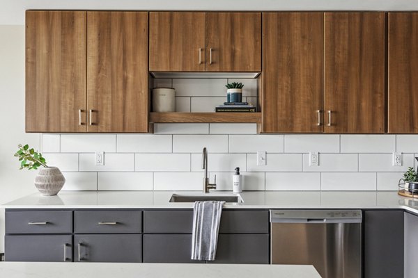 Modern kitchen with sleek cabinetry and stainless appliances in The Eddi Apartments