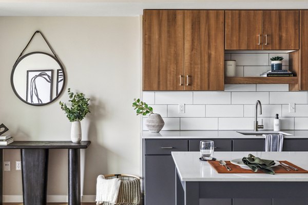Contemporary kitchen featuring stainless steel appliances at The Eddi Apartments