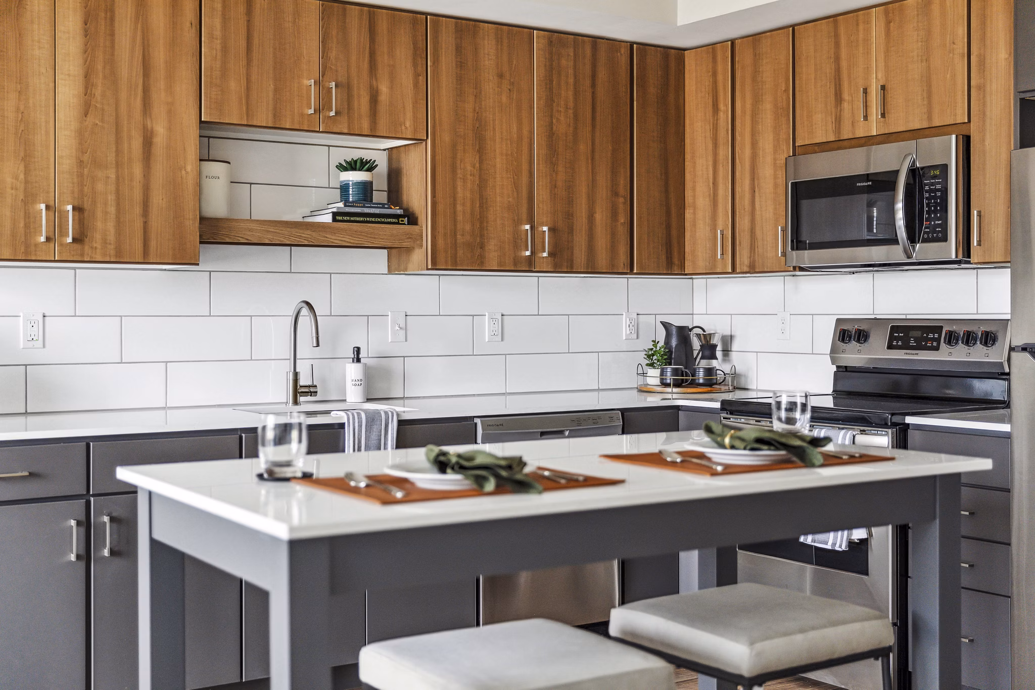 Modern kitchen with stainless steel appliances and spacious countertops at The Eddi Apartments