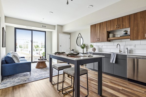 Modern kitchen with stainless steel appliances at The Eddi Apartments, offering luxury living spaces near urban conveniences