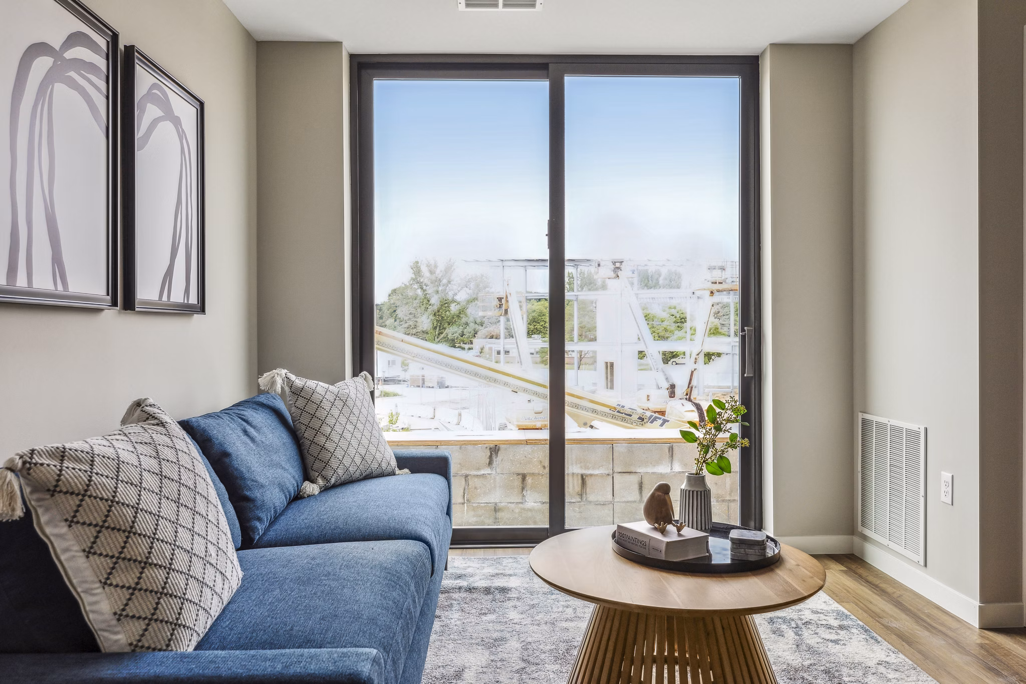 Modern living room with stylish furnishings and large windows in The Eddi Apartments, offering luxury living in a vibrant location