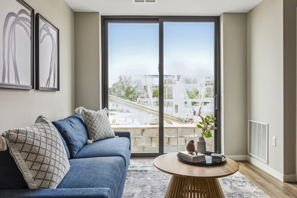 Modern living room with stylish furnishings and large windows in The Eddi Apartments, offering luxury living in a vibrant location