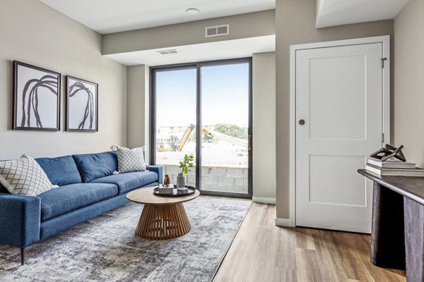 Spacious living room with modern decor at The Eddi Apartments