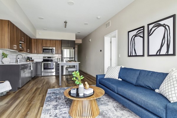 Living room featuring contemporary design and ample natural light at The Eddi Apartments