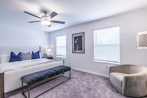 Cozy bedroom with plush bedding in Balcara 301 at Sun City Apartments