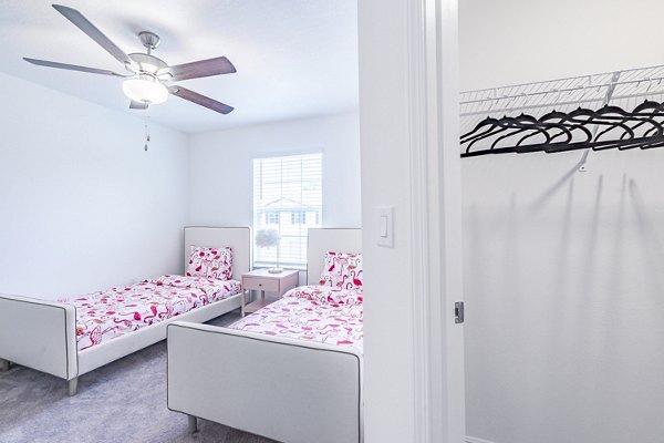Cozy bedroom with walk-in closet at Balcara 301 in Sun City Apartments offering luxury living spaces