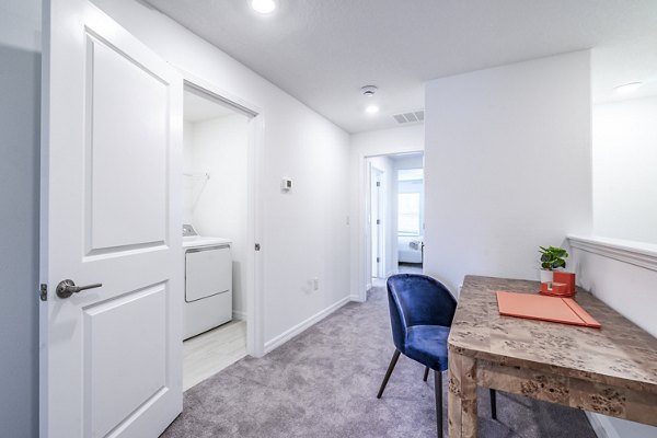 Hallway leading to home office and laundry room at Balcara 301 within luxury Sun City Apartments
