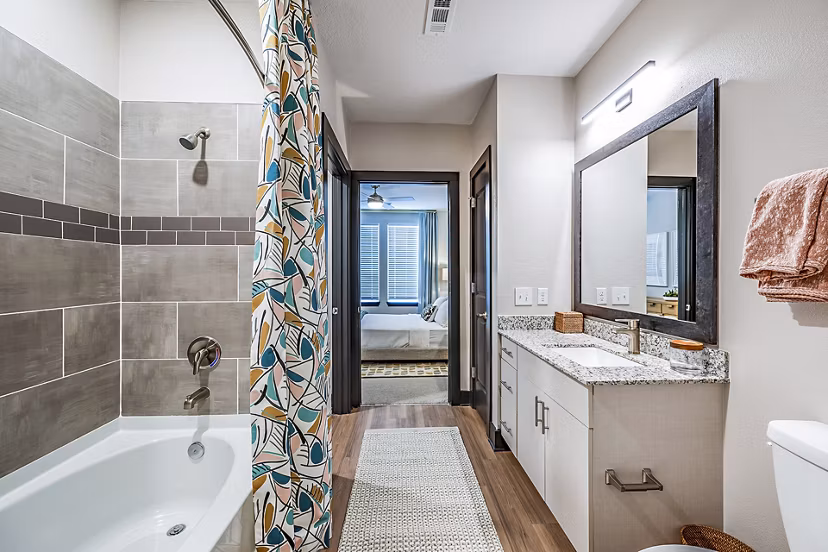 Luxury bathroom with marble countertops and glass shower in Presidium Regal Apartments