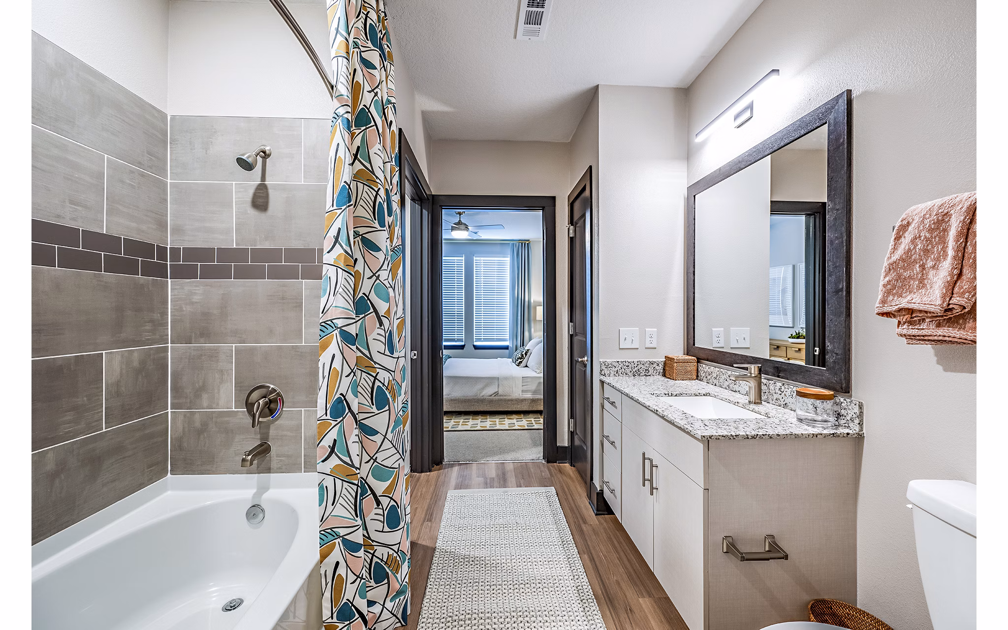 Luxury bathroom with marble countertops and glass shower in Presidium Regal Apartments