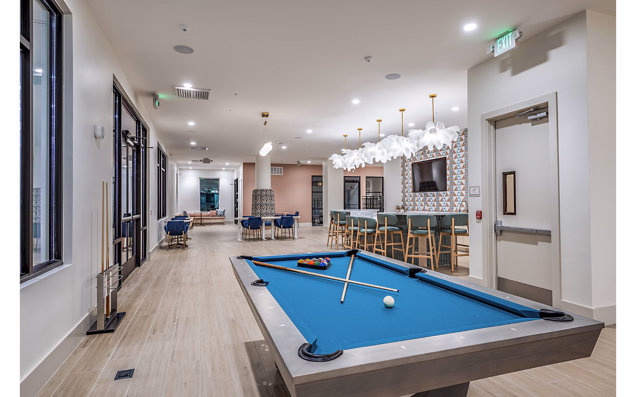 Clubhouse game room featuring billiards and lounge seating at Presidium Regal Apartments