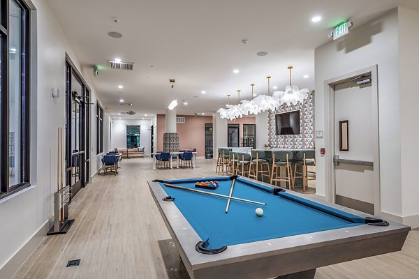 Clubhouse game room featuring billiards and lounge seating at Presidium Regal Apartments