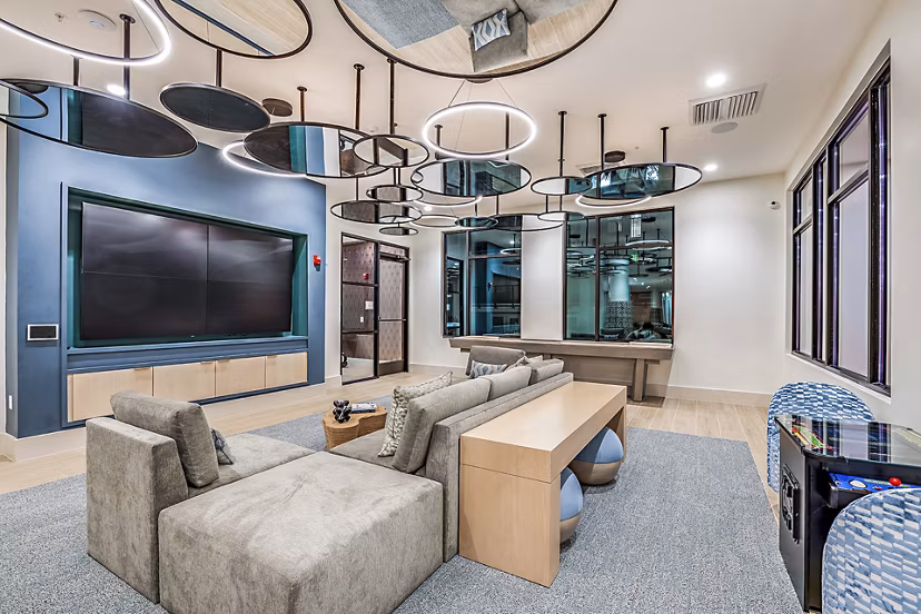 Clubhouse theater with plush seating and large screen at Presidium Regal Apartments