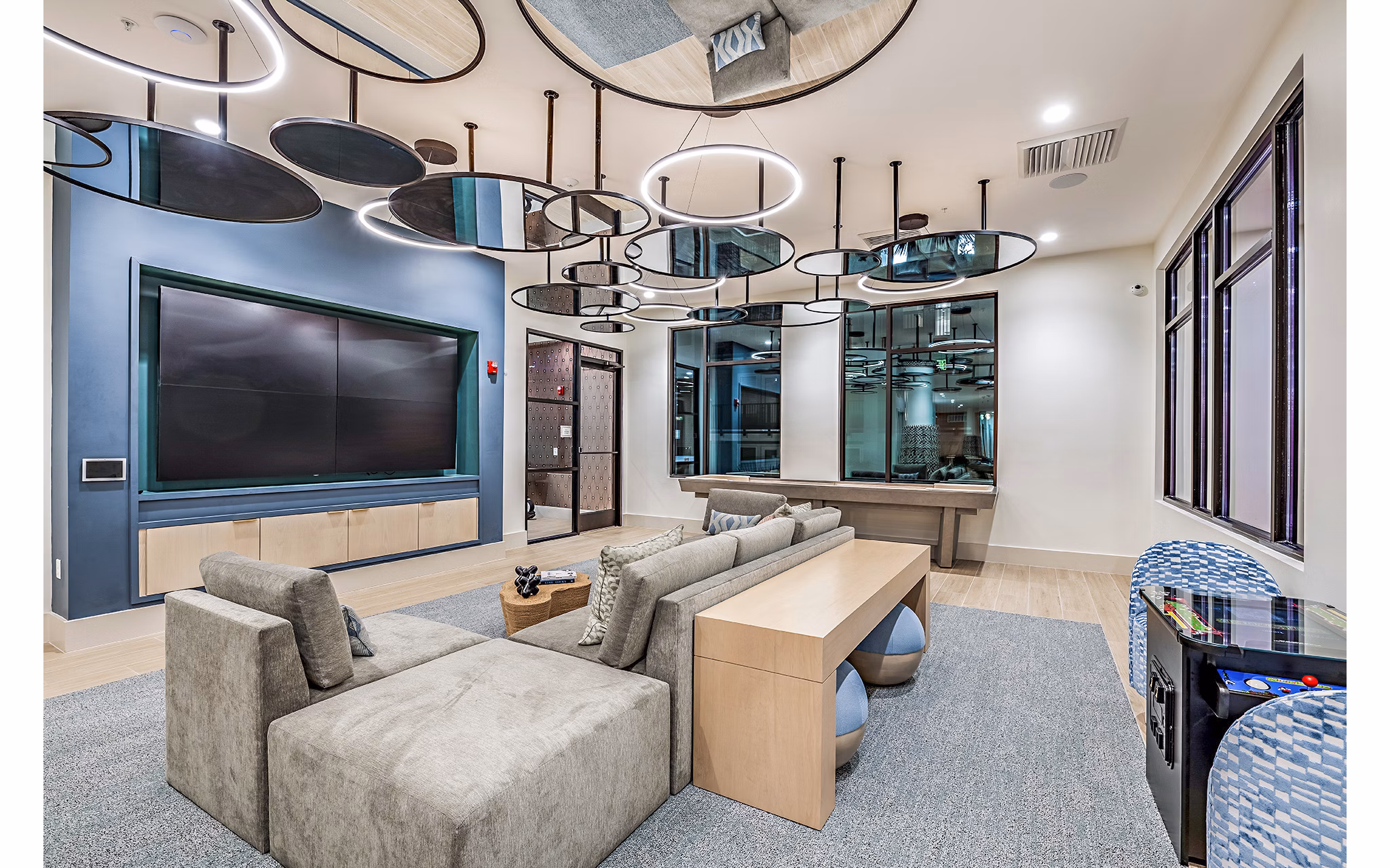 Clubhouse theater with plush seating and large screen at Presidium Regal Apartments