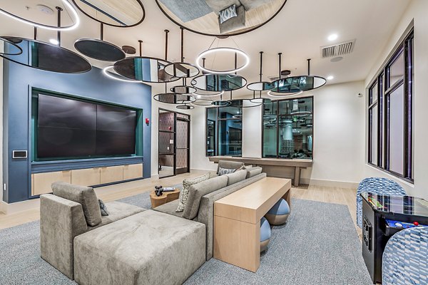 Clubhouse theater with plush seating and large screen at Presidium Regal Apartments