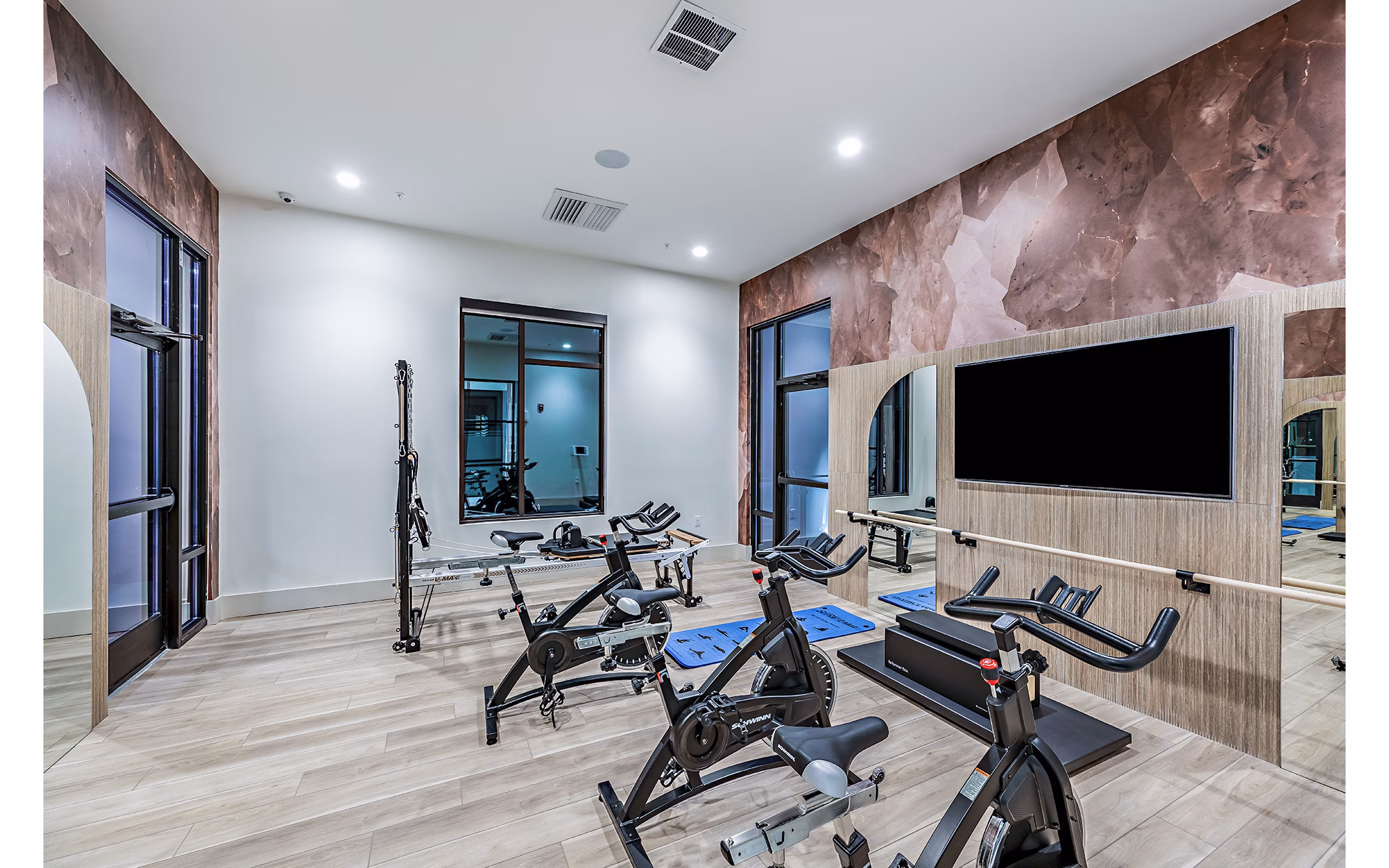 State-of-the-art spin studio with bikes and mirrors at Presidium Regal Apartments