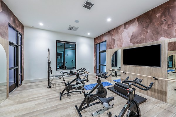 State-of-the-art spin studio with bikes and mirrors at Presidium Regal Apartments