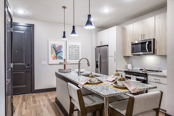 Kitchen with modern appliances and marble countertops at Presidium Regal Apartments, luxury living space