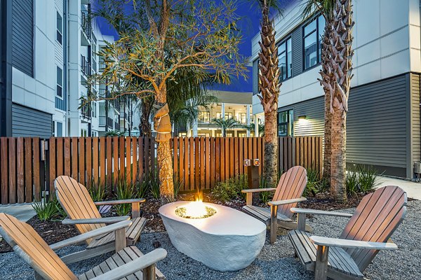 Cozy fire pit on the patio at Presidium Regal Apartments, creating a perfect outdoor gathering space in this luxurious complex