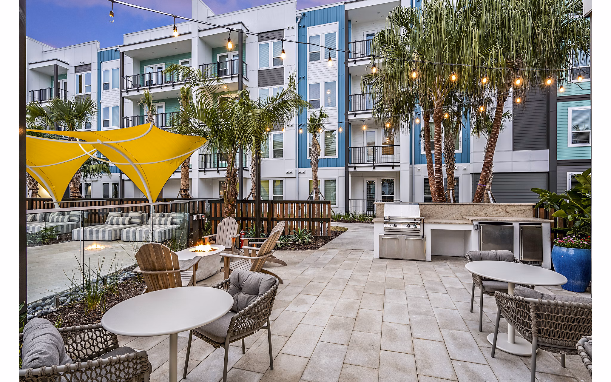 Grill area and modern fire pit on stylish patio at Presidium Regal Apartments