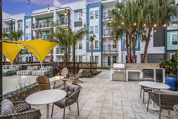 Grill area and modern fire pit on stylish patio at Presidium Regal Apartments