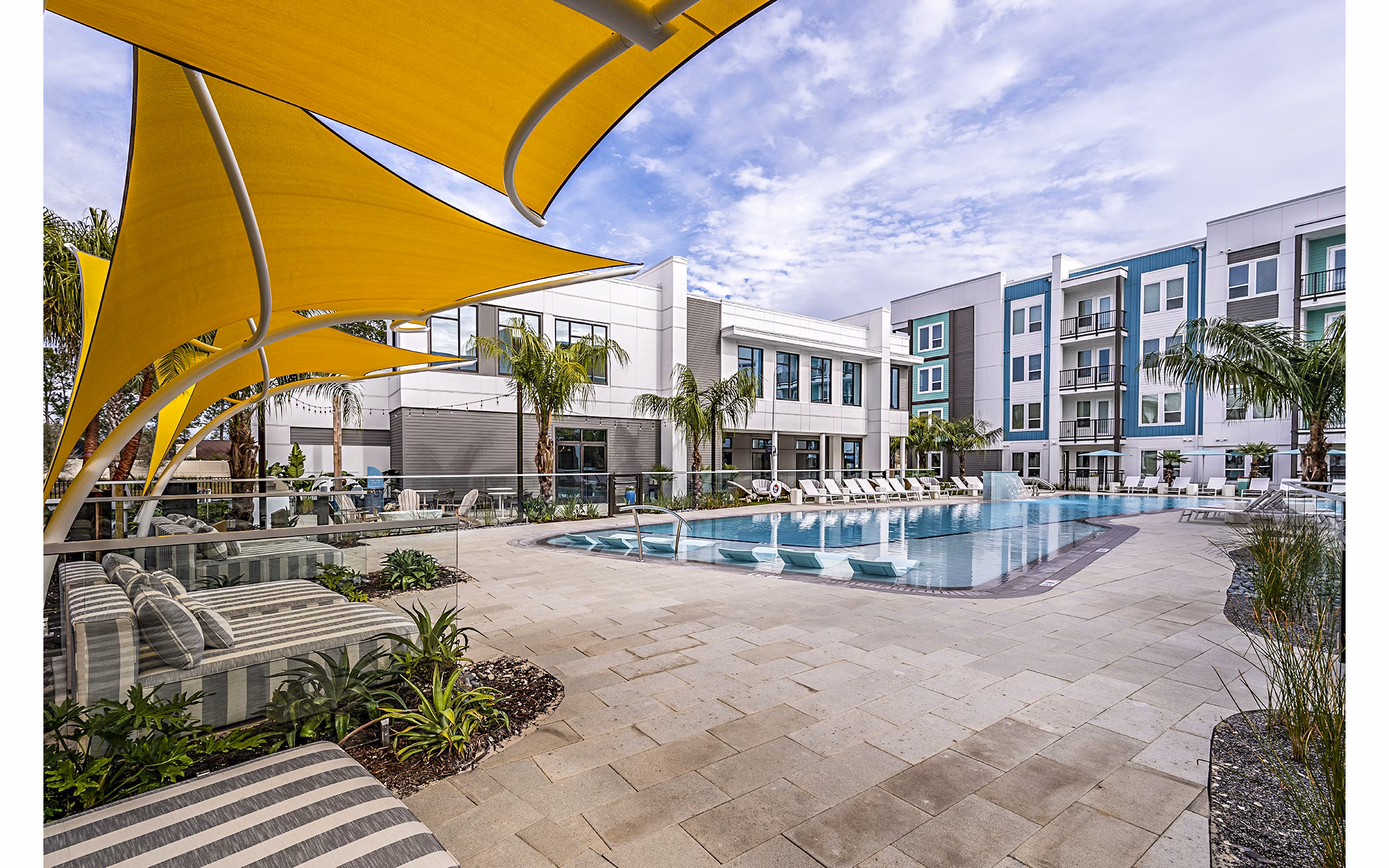 Resort-style pool at Presidium Regal Apartments with sun loungers and lush landscaping, offering a luxurious outdoor retreat for residents