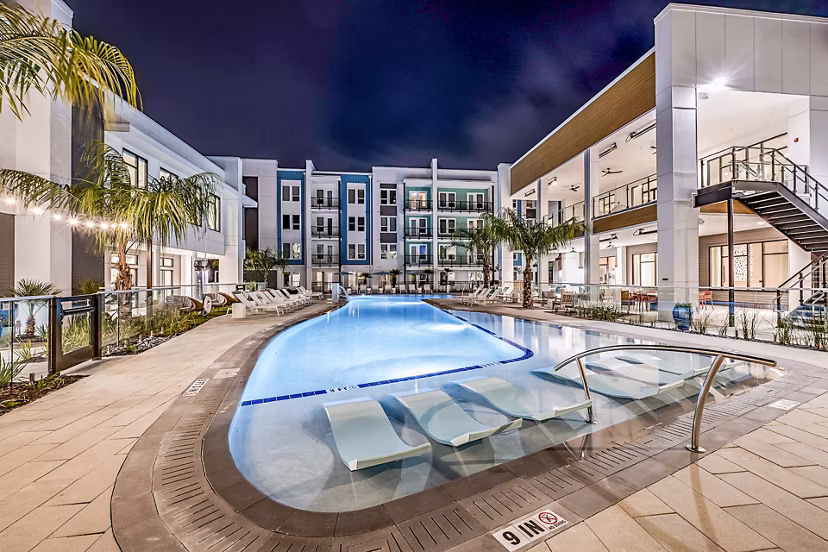 Luxury pool at Presidium Regal Apartments offering serene lounging experience with modern design and lush landscaping