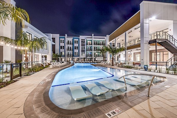 Luxury pool at Presidium Regal Apartments offering serene lounging experience with modern design and lush landscaping