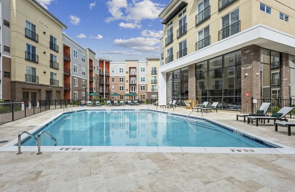 Resort-style pool with lounge seating at The Westlyn Apartments