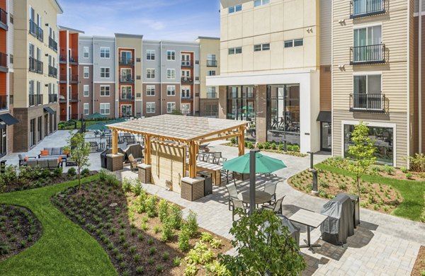 Courtyard with landscaped gardens and seating area at The Westlyn Apartments luxury community