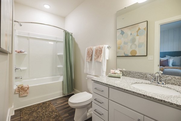 Modern bathroom with sleek fixtures and natural lighting at Riverwood Apartments