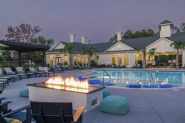 Resort-style pool with sun loungers at Riverwood Apartments luxury community