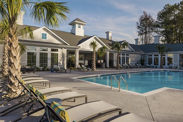Riverside pool with sun loungers at Riverwood Apartments