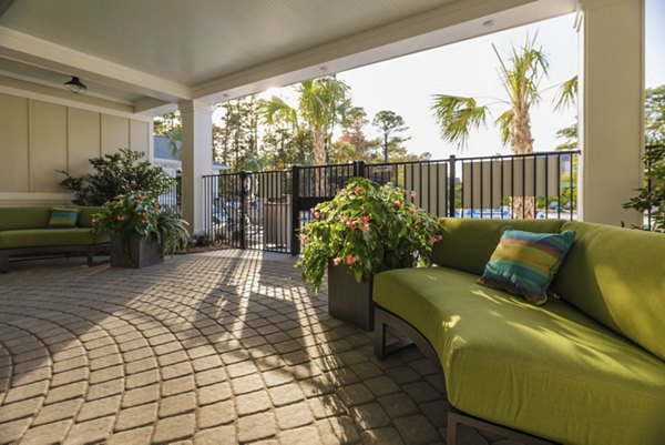 Stylish outdoor patio with modern seating at Riverwood Apartments
